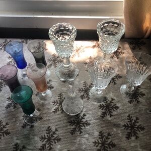 Crystal like candle holder and two glasses and bell and pretty colorful glasses